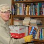 Volunteer Art Holtz sorts books in the Stone Church basement.  There's quite a pile!