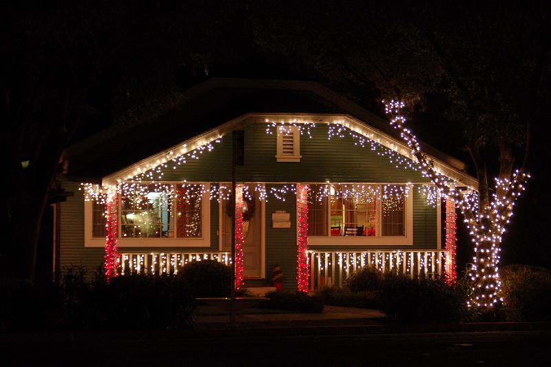 GingerbreadHouse.JPG - Outside, at night, a neighbors home sets the scene for Christmas.