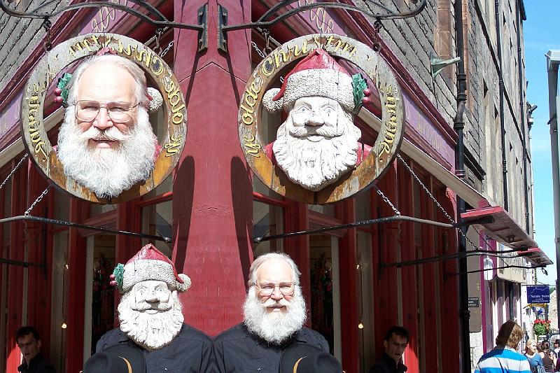 SantaSwitched.jpg - Earler this year, Stone Churchs resident Santa, Walter Roach (Lower Center), met his match in a sign outside a small shop (Upper Center).  Remarkably, their images got switched in the reflection (Left).