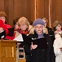 As the party sets out, choir sings encouragement.