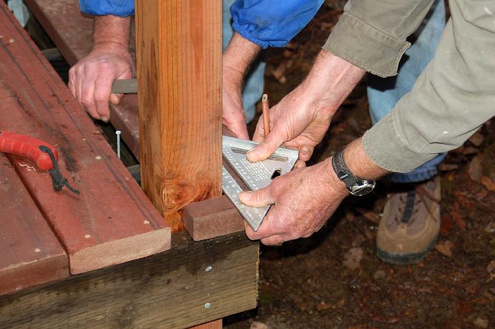DSC_0079.JPG - A piece of Trex flooring is carefully measured for fitting around a post.