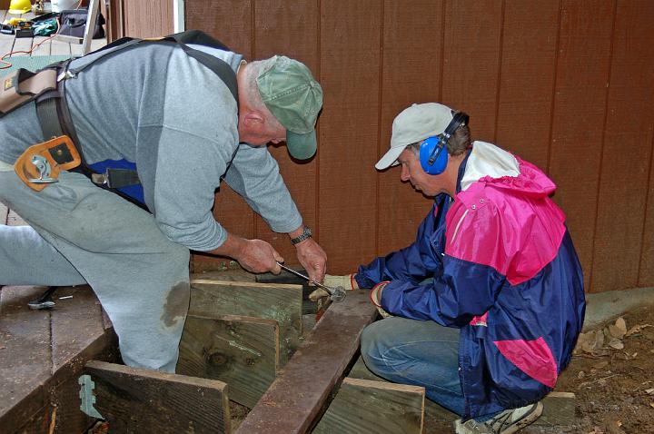 DSC_0081.JPG - Lawrence and Gabriel trim a board for use on a step.