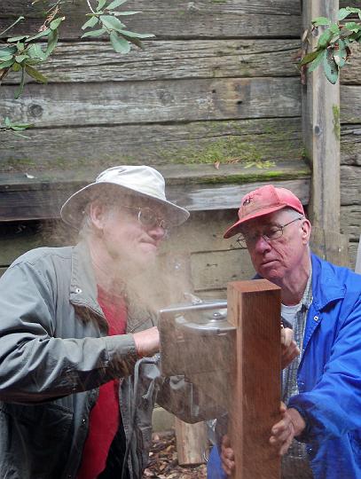 DSC_0087.JPG - Sawdust flies as Art (holding saw) and Gary trim a post.