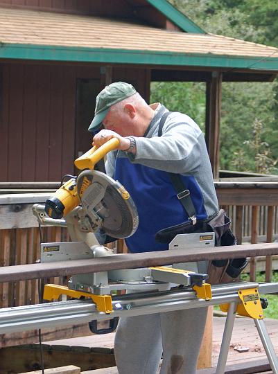 DSC_0091.JPG - Lawrence adjusts the power saw for an angle cut.