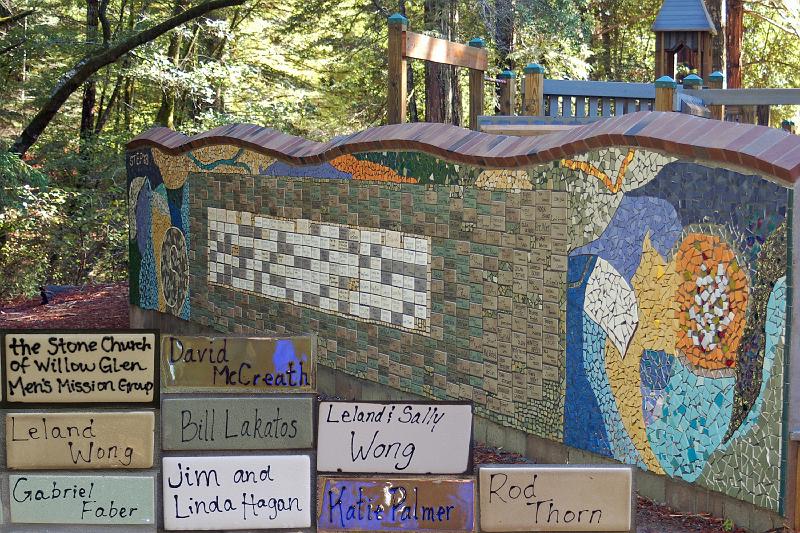 Mosaic.jpg - We visit the mosaic in back of Westminster Woods superb Childrens Playground, and find (foreground) tiles recognizing several Stone Church members for their help in building the Playground.