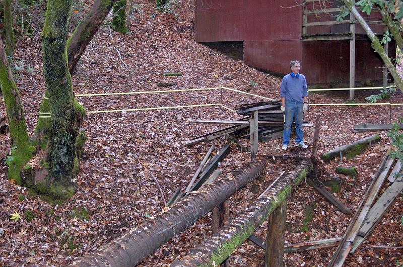 BR_0024.JPG - Gabriel surveys the scene, once all of the walkway boards have been removed.  Nails will now be pulled from all lumber pieces so the wood can be used in fireplaces.