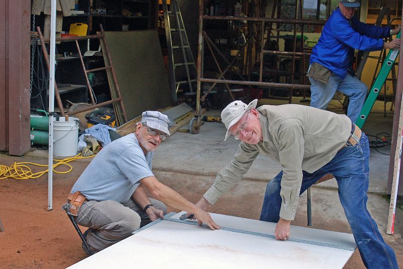 DR_0064.JPG - David (left) and Art Holtz measure the next piece of drywall for cutting to size.