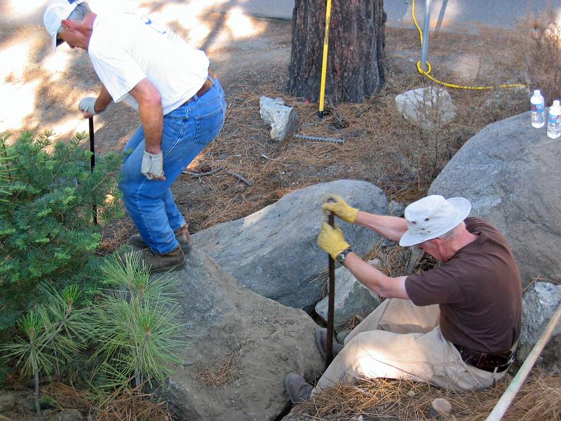 117_1746.jpg - John Lococo and Art Holtz moving a boulder.