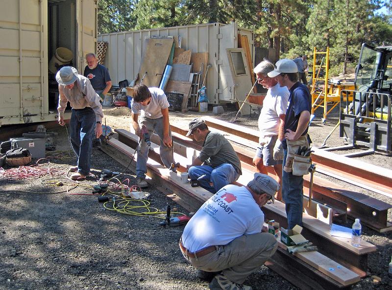 202.jpg - Steel I-beams will provide the foundation for our roof.  Here, wood is being bolted to the beams to provide a surface for nailing into.