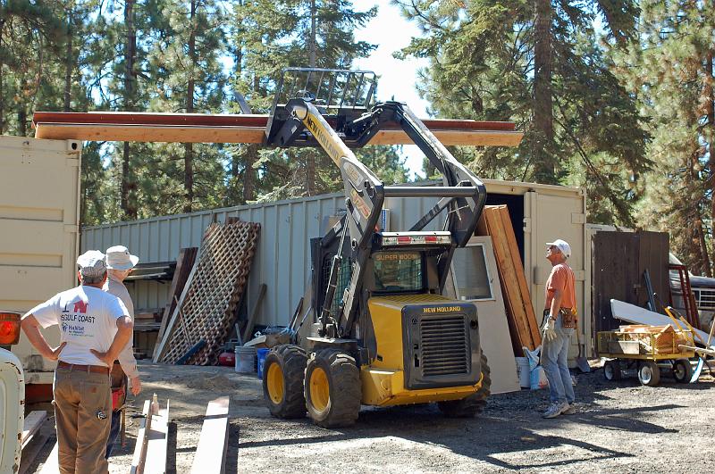 203.jpg - The first beam is hoisted into place.