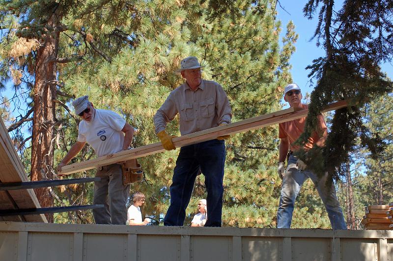 207.jpg - David McCreath, Art Holtz and John Lococo help offload the timber for purlins.