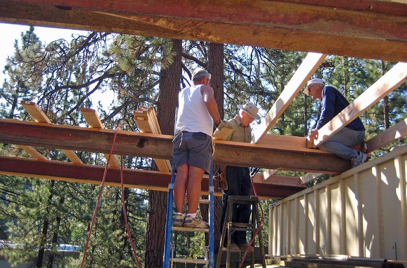 313.jpg - More boards, more measuring, more nails and more hammering, keep (L-R) Michael, Art and John busy.