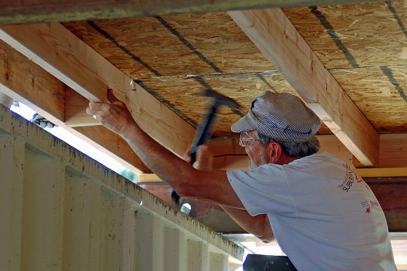 405.jpg - David McCreath nails a spacer into place.