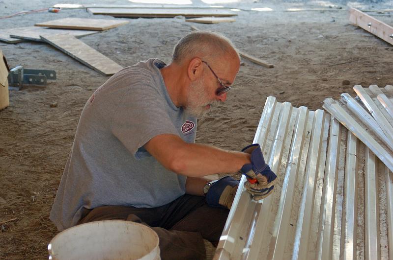 406.jpg - Bill removes screws from plastic material that will form the back wall, between the two steel containers.