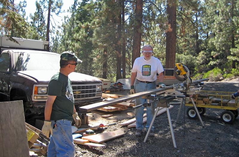 408.jpg - Leland watches as Rod cuts a board to size for the construction project.