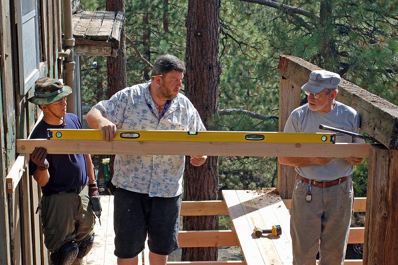 DSC_0031.JPG - Leland, Mark and David check where to trim an old supporting beam on the High Deck.