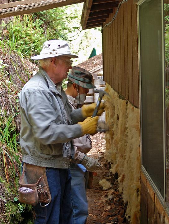 M10-11.JPG - Art Holtz and Leland Wong remove rotten siding from the lower half of the dining room exterior wall.  Much water and no sunshine hits this cramped walkway area.  (Mar 2010)