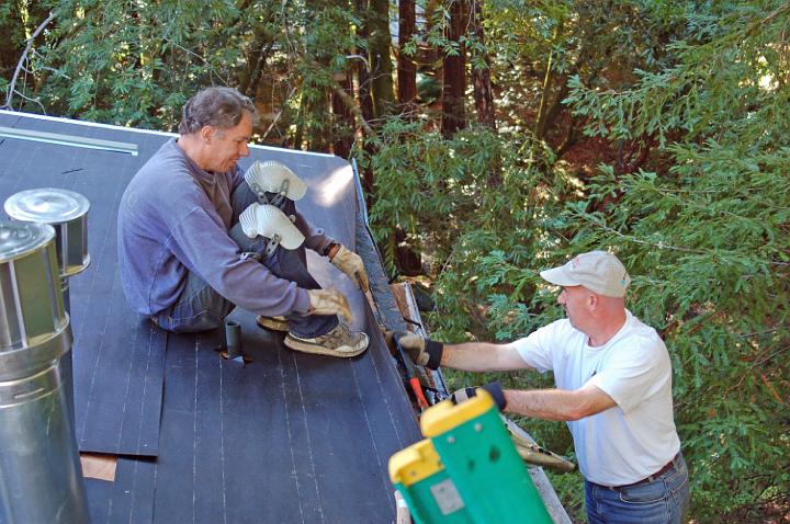 O09-36.JPG - Gabriel Faber and Craig Bowers remove a gutter, while reroofing a cabin.  (Oct 2009)