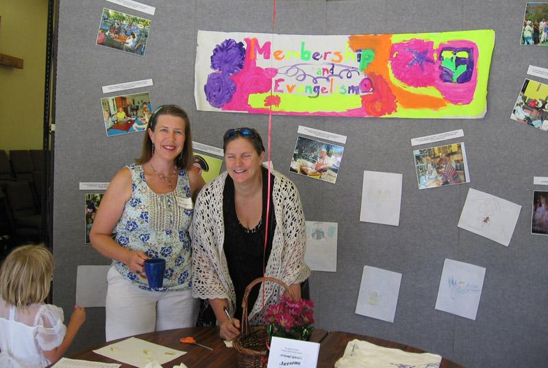 IMG_0693.jpg - Ellen (holding cup) with her Membership and Evangelism Committee display.