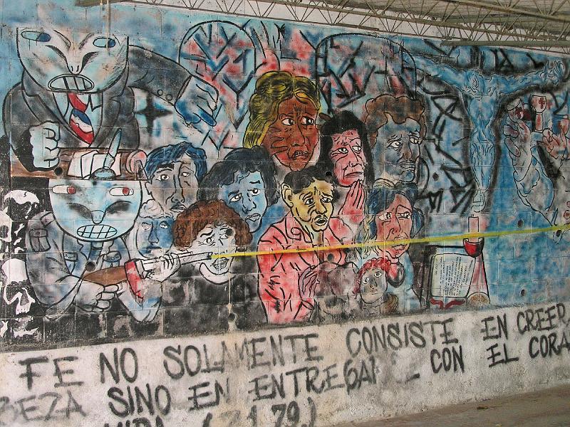 D001.jpg - Mural of Terror, showing the assassination of Archbishop Romero by oligarchy and army, plus Romero quote:  Faith doesnt only consist in belief with the head but in dedicating ones heart and life.