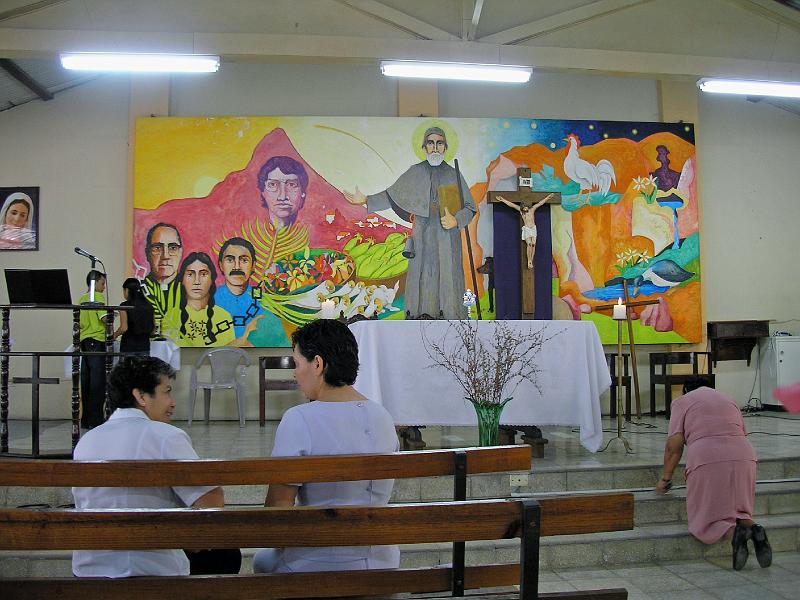 D006.jpg - We worshipped at Iglesia Bambue which features this mural with Archbishop Romero on the left and Padre Octavio Ortiz, 4th from the left.