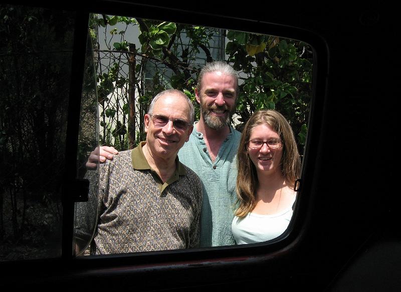 MK167.jpg - Seen though van window:  John, delegation member (left), Roddy, Executive Director of VOTB (center), and Rosie VOTBs Field Director (right).  VOTB facilitates and assures effective use of all donations from SBSC in a manner that empowers the Salvadorans as they grow in selfsufficiency.
