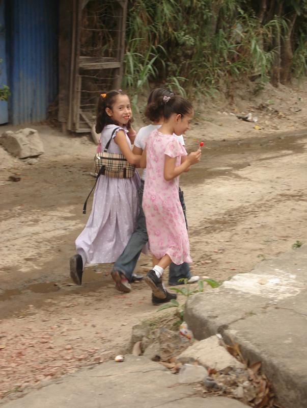 S086.jpg - Girls in their Sunday best walk home after church.