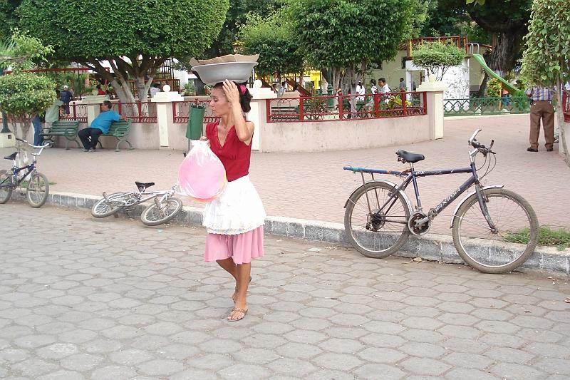 S437.jpg - A colorful plaza and a typical way women carry things.